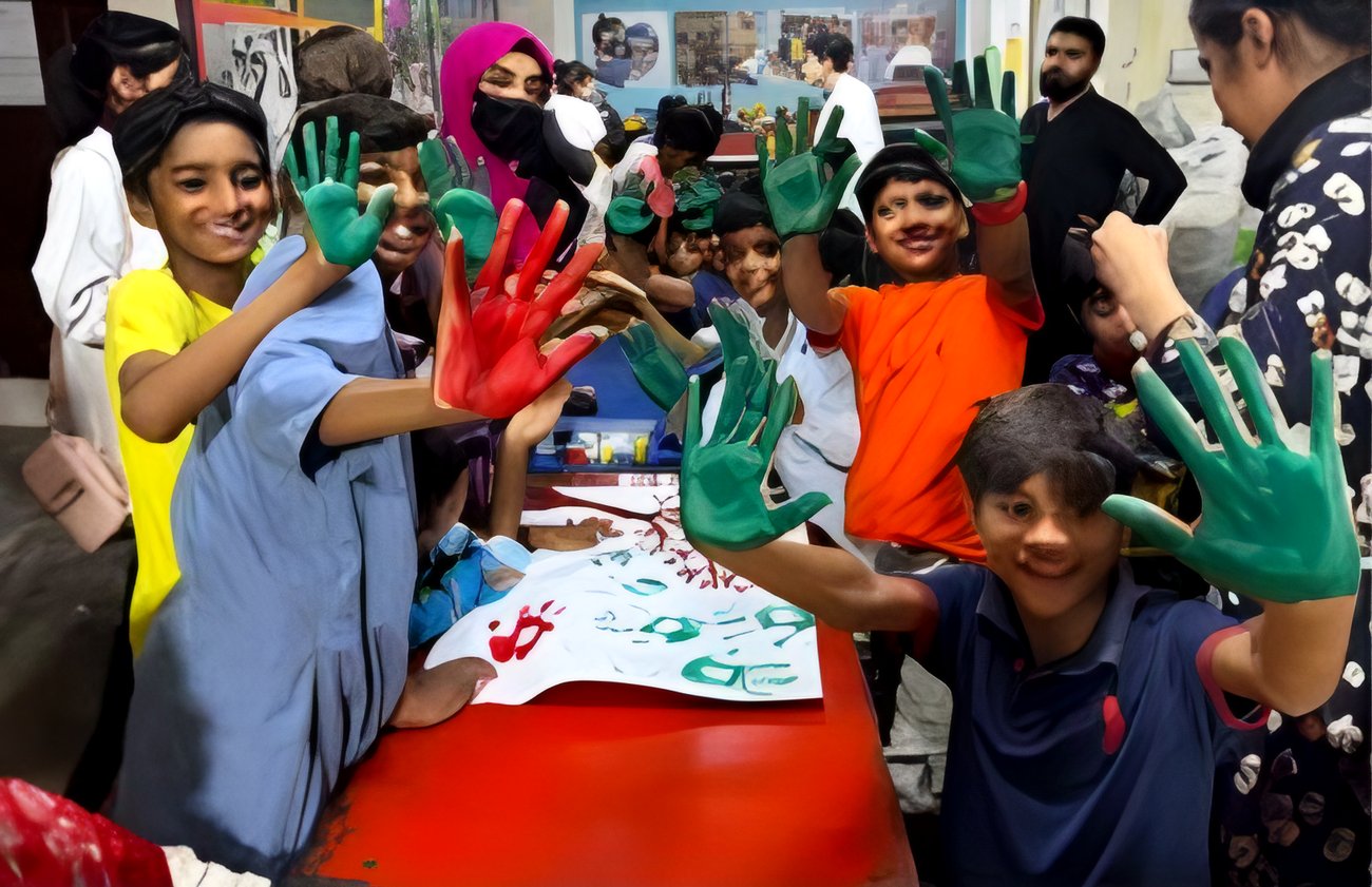 Children with painted hands at an art workshop