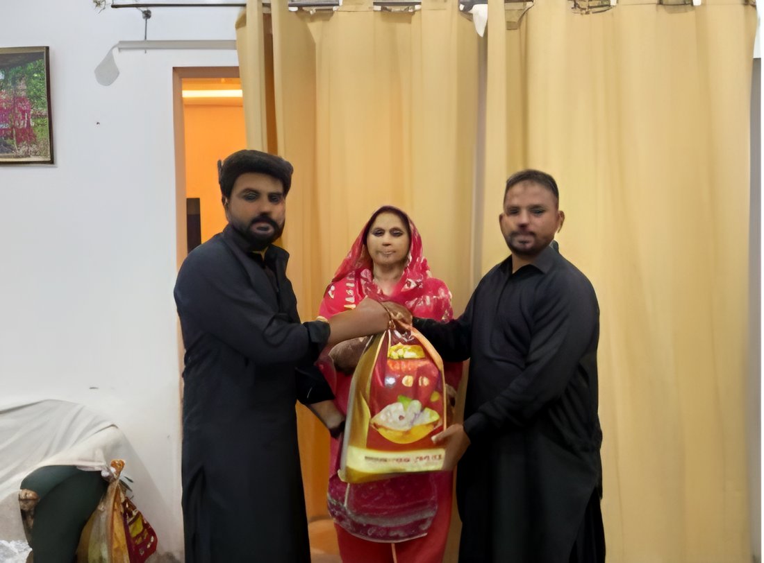 Volunteers giving a gift bag to a mother
