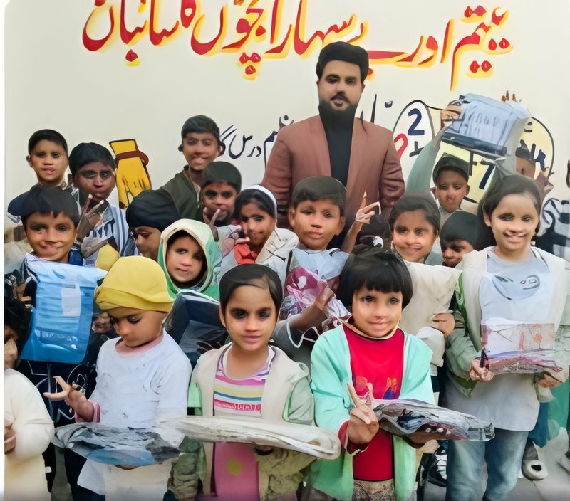 Children holding up gifts they received from the foundation